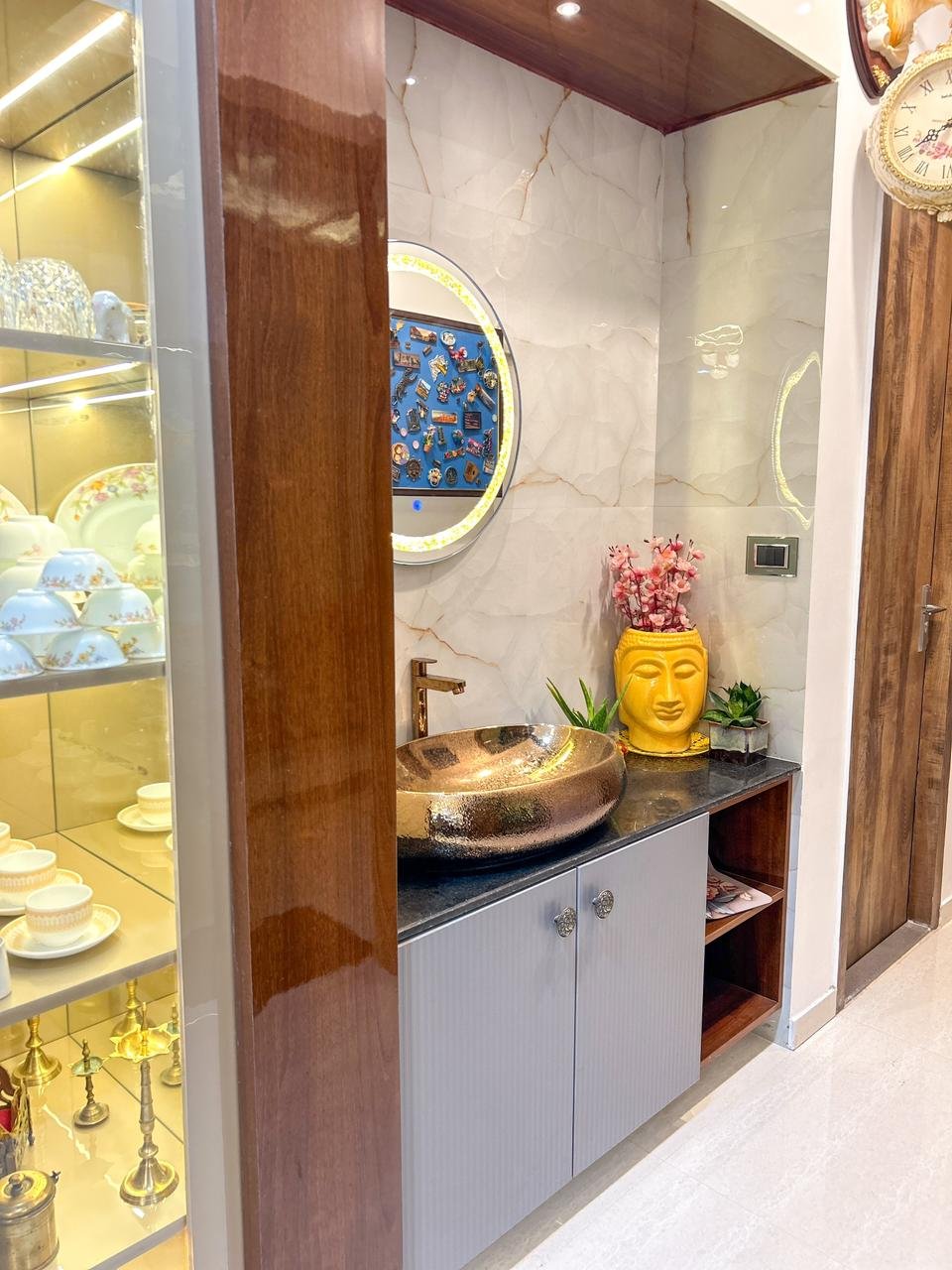 Luxury entry interior detail with wood stone and display lighting by Doric & Co. Pune